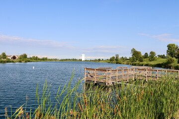 The old wood fishing dock at the lake on a sunny day.