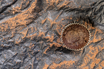 fresh and soft black chocolate cupcake on black paper