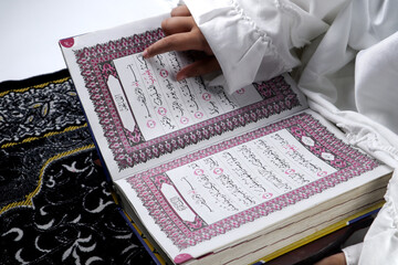 Muslim woman reading the holy quran at the holy month of Ramadan