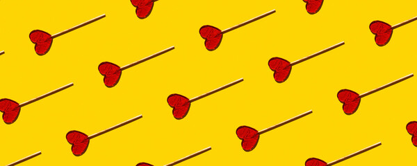 Seamless pattern of heart-shaped lollipops