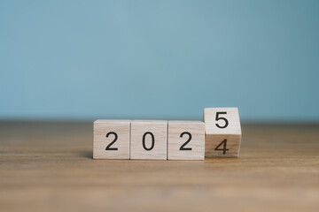 2024 Business and customer review for next year's business strategy planning 2025 Flip of 2024 2025 on wooden blocks. End-of-year business ideas.