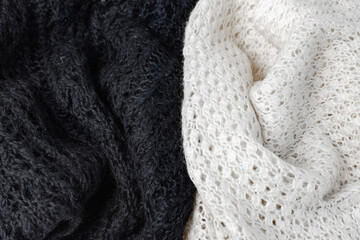 Background of two knitted openwork products in black and white