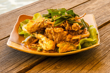 Fresh raw crab with blue claws cooking in a wok with a green pepper sauce, a specialty of Kep, Cambodia