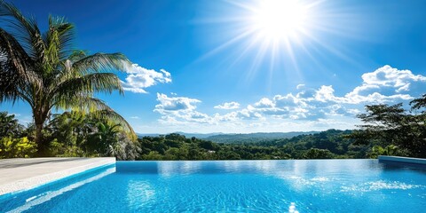 A calm swimming pool sits under a bright, clear blue sky, surrounded by a beautiful natural landscape that enhances the serene atmosphere.