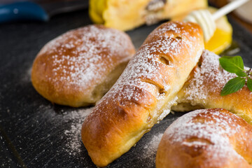 Pastries. Sweet buns with quince and honey filling, on a wooden table