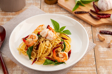 Stir Fried Spaghetti with Dried Chili and garlic with Shrimp in white plate.
