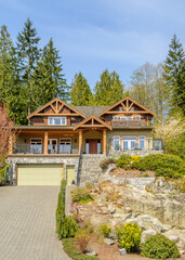 Two story stucco luxury house with nice summer  landscape in Vancouver, Canada, North America. Day time on June 2024.