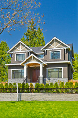 Two story stucco luxury house with nice summer  landscape in Vancouver, Canada, North America. Day time on June 2024.