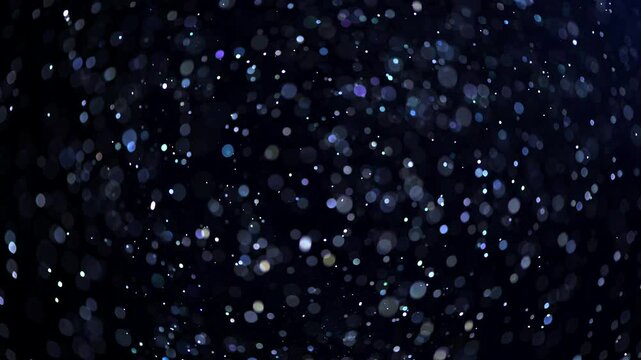 Floating abstract particles background, dust falling, flying magic blue sparks, glitter neon sparkles isolated on black. Blye particles, Dust. Christmas particles flying bokeh. Holiday backdrop. 