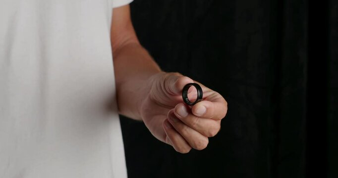Man Puts on a Smart Ring, Heart Rate, Blood Oxygen Tracker, Calorie Sleep Tracker. Close-up. 