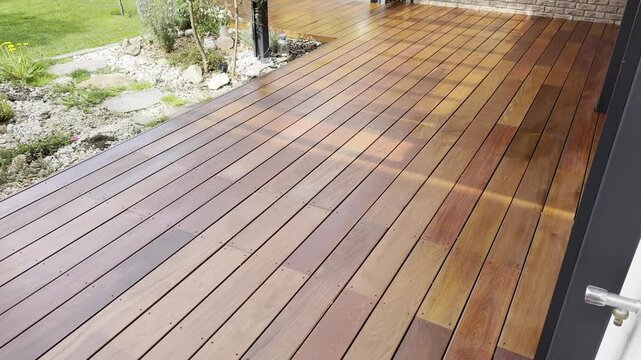 Ipe wood deck house terrace against brick wall