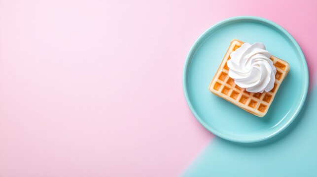 A delicious waffle topped with whipped cream, placed on a vibrant turquoise plate against a soft pink background, Perfect for food blogs, menus, or social media posts promoting sweet treats,