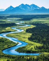 Fototapeta premium Serene Aerial View of Winding River Flowing Through Lush Green Landscape Surrounded by Majestic Mountains Under Clear Blue Sky