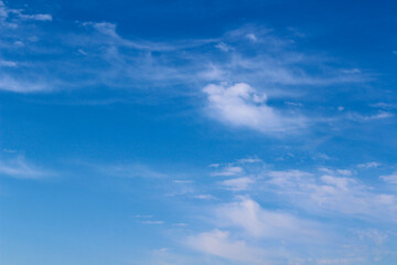 blue sky background with blurred light white clouds