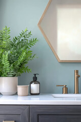 Modern bathroom decor featuring a hexagon mirror, blue and minimalist