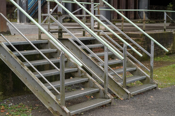 Two metal industrial stairways leading to an abandoned factory