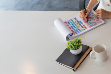 Young designers are choosing color schemes to use in their ux ui website design and working with...
