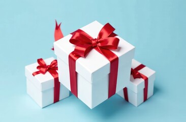 Obraz premium white gift boxes with red satin ribbon on blue background