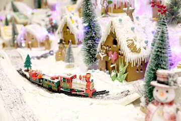 Christmas decorations with snowman, gingerbread houses, snow and spruce trees.