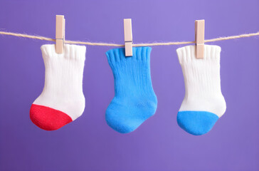 Cute and Colorful Baby Socks Drying on a String with Clothespins, AI GENERATIVE 