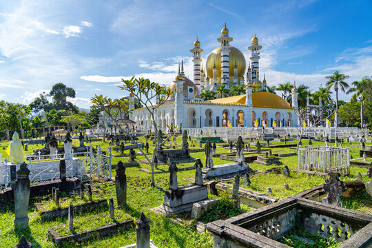 View over the Ubudiah Mosque with a muslim cemetery in the foreground in Kuala Kangsar, Perak, Malaysia 
