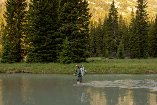 A young man crosses the Green River en route to Gannett Peak in Wyoming on July 14, 2024.