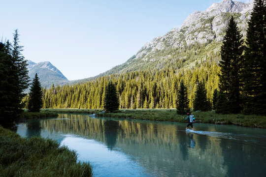 A young man crosses the Green River en route to Gannett Peak in Wyoming on July 14, 2024.