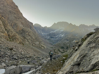 Fototapeta premium A young man enjoys a backpacking trip in the Wind River Range in Wyoming.