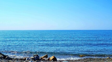 Fototapeta premium Serene Coastal Scene With Blue Ocean And Rocks