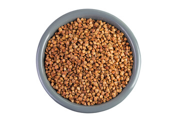 Raw buckwheat in ceramic bowl isolated on white background. Top view. Flat lay