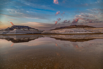 Kazakhstan, Mangistau, Mangyshlak, Tuzbair. Geological chalk formations. The process of destruction of the ancient Tethys Ocean. Salt lake with a thin layer. Reflection of the sunset