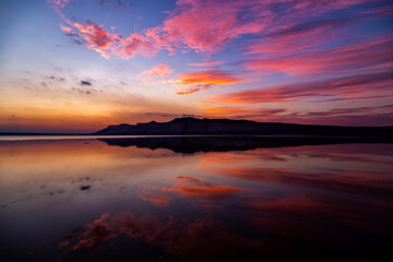 Kazakhstan, Mangistau, Mangyshlak, Tuzbair. Geological chalk formations. The process of destruction of the ancient Tethys Ocean. Salt lake with a thin layer. Reflection of the sunset