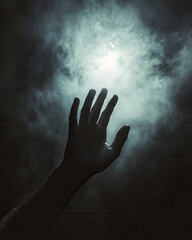 A mysterious hand reaches toward an ethereal light amidst the fog in a dark, cinematic atmosphere at twilight