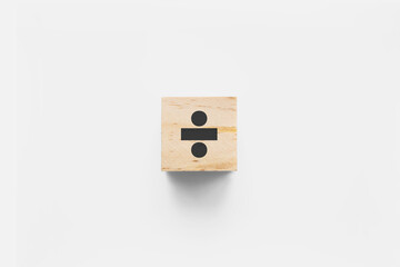 ÷ (Division) wooden cube on white background