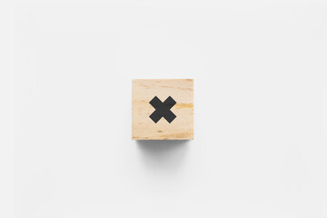 &times; (Times) wooden cube on white background
