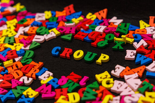 Colorful Wooden Letters Spelling "CROUP" on a Black Background for a Distinctive Health Awareness Visual