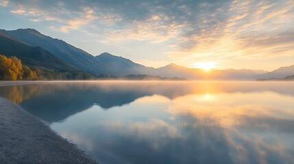 Obraz premium Serene Sunrise Over Calm Lake And Mountains