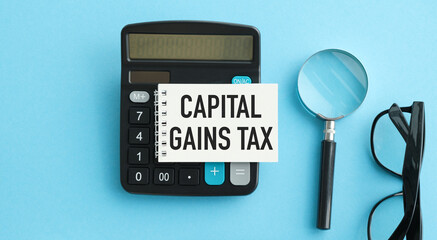 Capital gains tax-text label in the form of a document Registrar planning folder. Mandatory gratuitous payment is established by law by the state government.