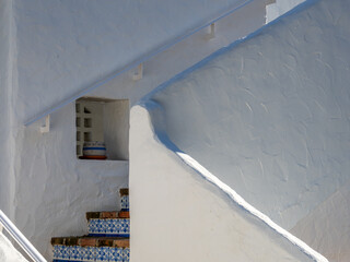 White facade of a Mediterranean coastal house with little windows 