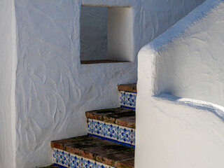 White facade of a Mediterranean coastal house with little windows 