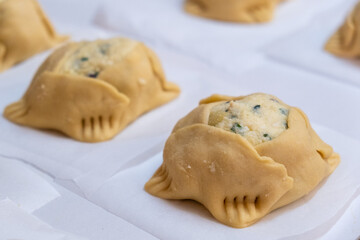 Easter cheese pastries flaounes ready to be cooked on a clay oven.