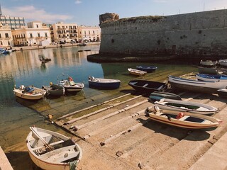 This charming waterfront view features a variety of boats elegantly docked in the calm and tranquil...