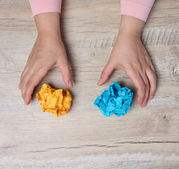 A woman's hand holding a crumpled sheet of paper, symbolizing the concept of new ideas and...