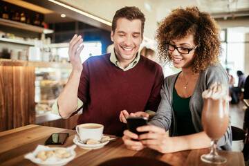 Young couple having a cup of coffee together in a cafe