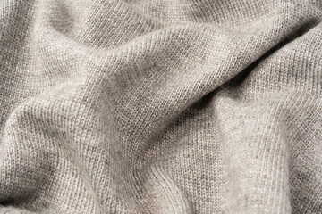 Grey wool sweater texture as a background.