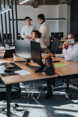 Obraz premium A diverse group of business people engaged in brainstorming and analyzing documents. They work collaboratively in a modern, open office environment, sharing ideas and planning projects efficiently.
