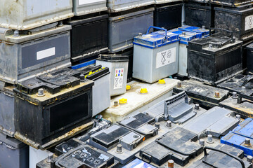 Stack of many used car batteries for recycling in a hazardous waste facility