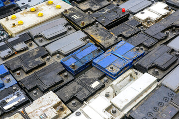 Stack of many used car batteries for recycling in a hazardous waste facility