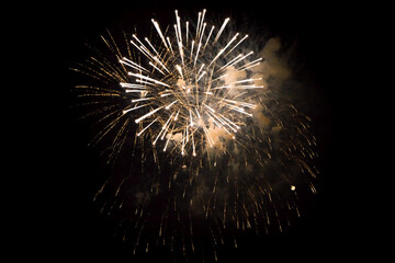 White yellow fireworks closeup in black background.