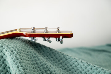 closeup of acoustic guitar headstock with die cast machine heads or tuning pegs